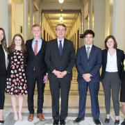 Group of 7 student interns with Senator Michael Bennet center 