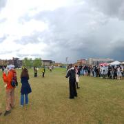 Auraria protestors on the quad linking arms facing police grouped in front of the Tivoli