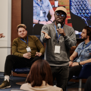 Young man speaking to group of people