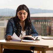 Student reading at a desk