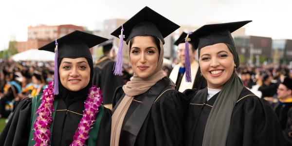 Three graduates in robes