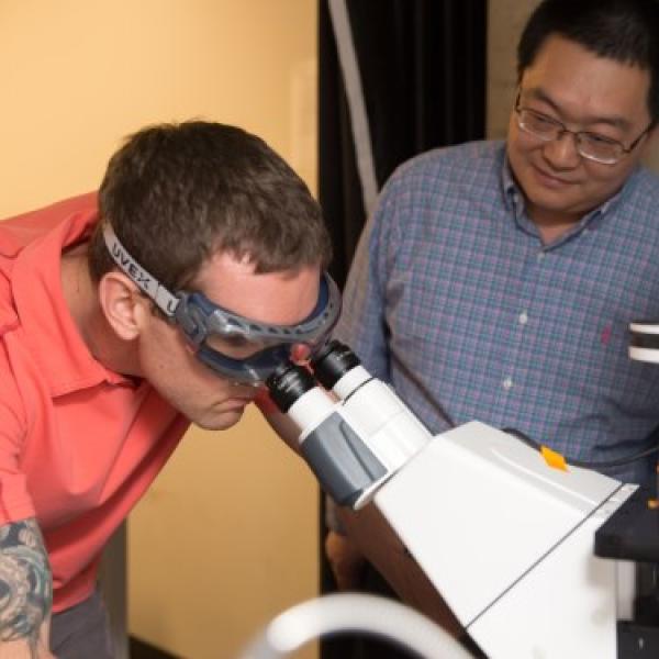 Student looking in microscope