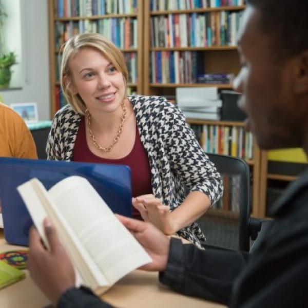 Students discussing a book