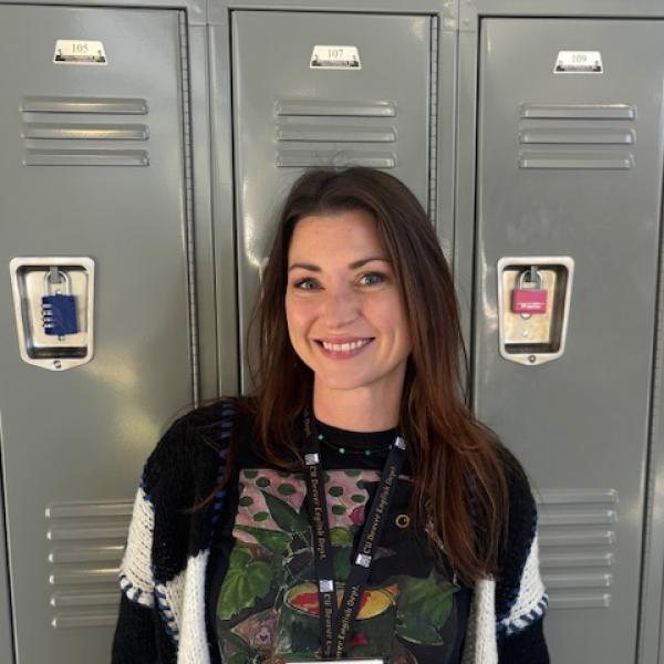Dayna smiling in front of silver lockers
