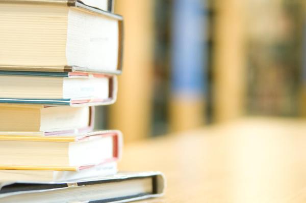 A picture of a stack of books with a blurred background