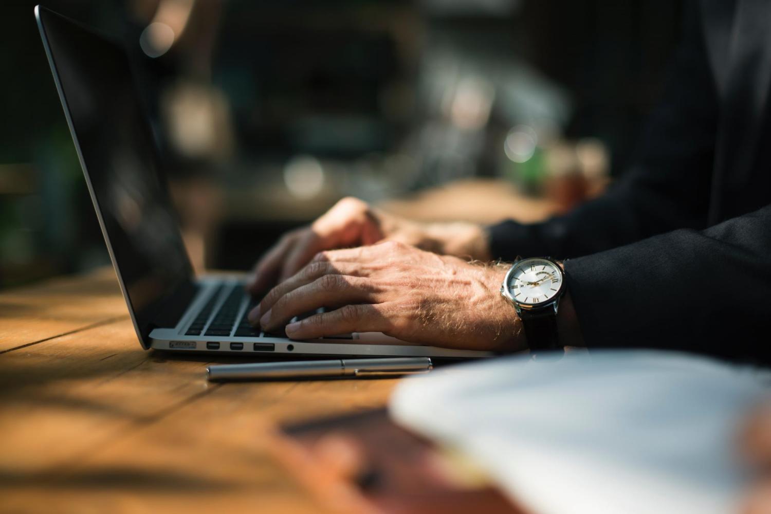 image of hands typing on laptop