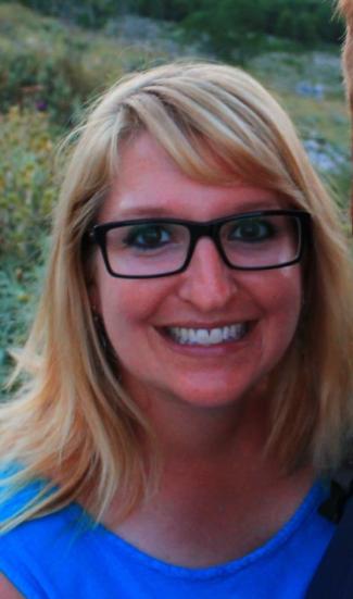 Headshot of Bekah Wright wearing a blue shirt and glasses