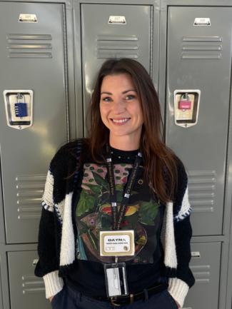 Dayna smiling in front of silver lockers