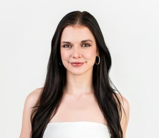 Headshot of Kyra on a white background
